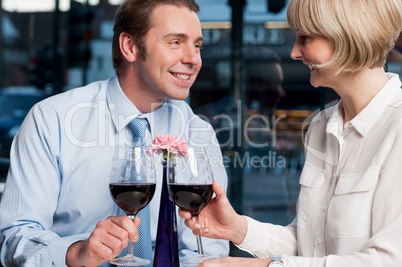 Happy couple toasting red wine