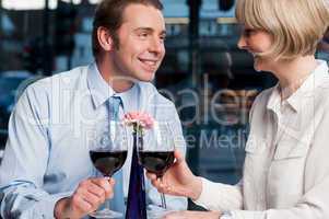Happy couple toasting red wine
