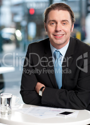 Smiling businessman at cafe