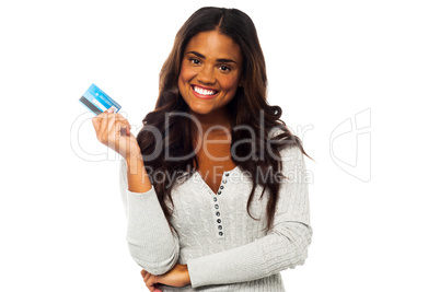 Young woman holding up a credit card