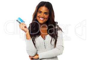 Young woman holding up a credit card