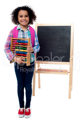 School girl with abacus and pink backpack