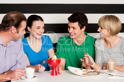 Happy family of four in restaurant