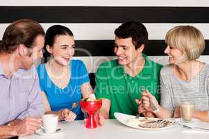 Happy family of four in restaurant