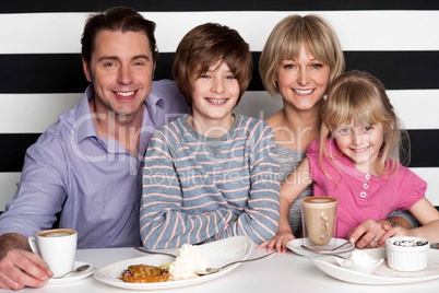 Family of four having great time in restaurant