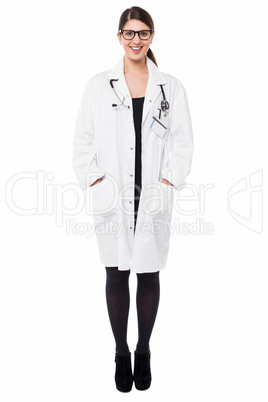 Female physician posing with hands in lab coat