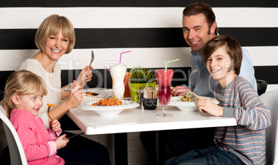 Family eating lunch together in restaurant