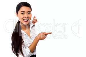 Business lady pointing towards ad on billboard