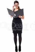 Corporate woman reviewing annual document
