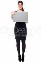 Smart businesswoman holding a laptop
