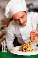 Professional chef preparing baked salmon to be served