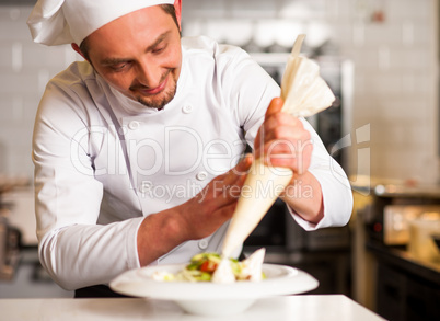 Professional chef decorating the dish