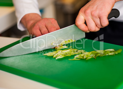 Chef chopping leek and doing preparations