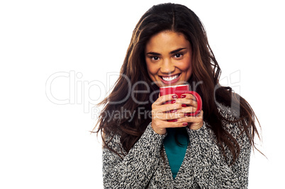 Relaxed mixed race woman having coffee