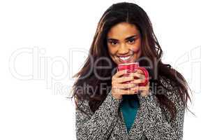 Relaxed mixed race woman having coffee