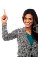 Smiling woman pointing upwards