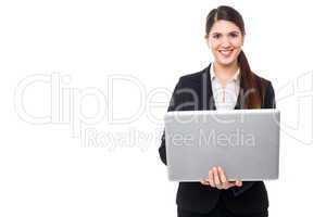 Attractive woman in formals working on laptop