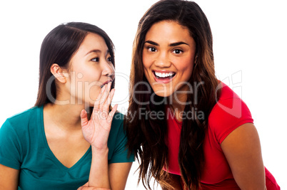 Two young girls gossiping