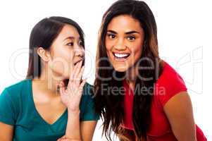 Two young girls gossiping