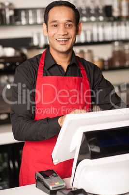 Cheerful barista staff at the cash counter