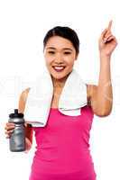 Smiling fitness woman holding sipper bottle
