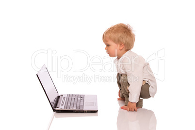 Young boy looking at a laptop