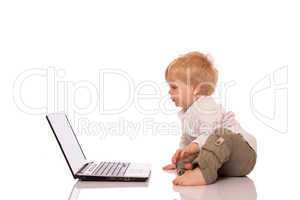 Young boy looking at a laptop