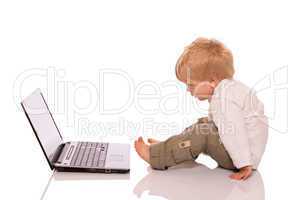 Young boy looking at a laptop