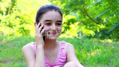 Beautiful smiling teenage girl talking on mobile phone