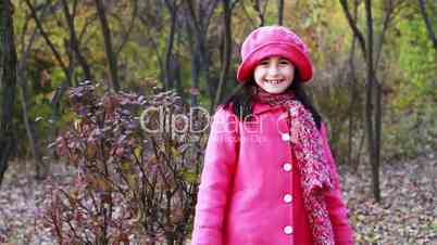 Little girl walking through the woods