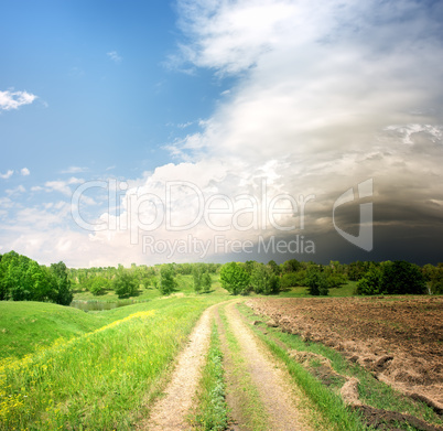 Country road and storm clouds