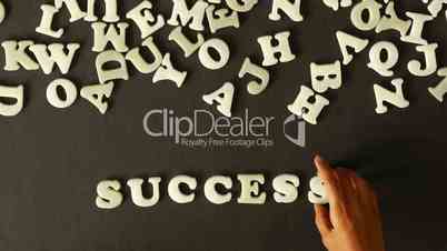 A person spelling Success