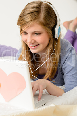Young teenage girl chatting on laptop
