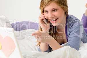 Laughing teenager relaxing by speaking on phone