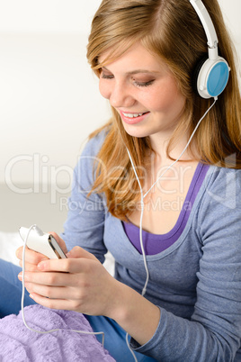 Pretty teenage girl listening to music