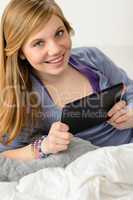 Happy young girl using digital tablet