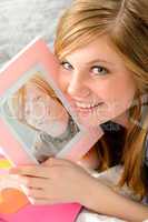 Teenage girl holding picture of her love