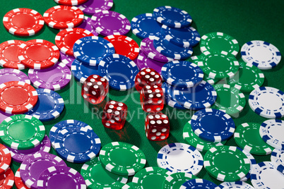 Colorful poker chips and red dice