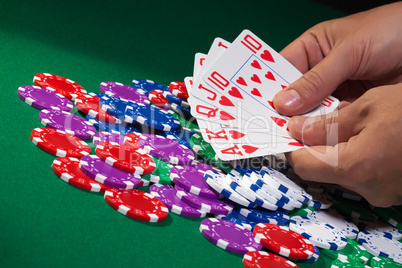 Colorful poker chips and royal flush