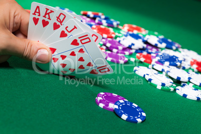Colorful poker chips and royal flush