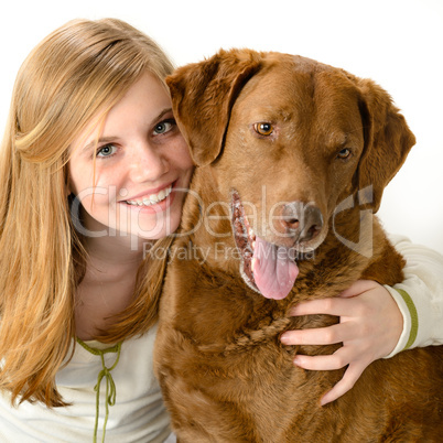 Young smiling girl with her playful dog