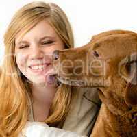 Portrait of girl snuggling with her dog