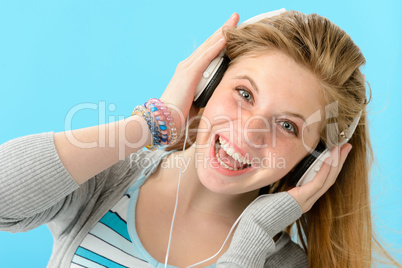 Cheerful girl listening to music with headphones