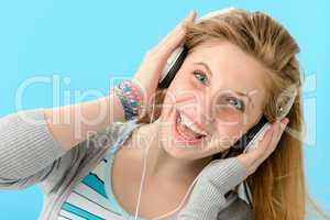 Cheerful girl listening to music with headphones