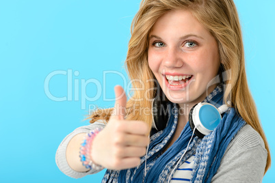Cheerful teenage girl showing thumbs up