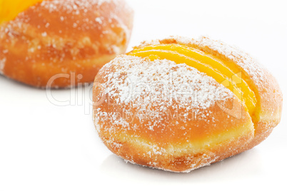 Two Berliner with egg creme over white