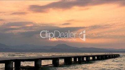 timelapse sunrise by garda lake italy with pier view