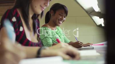 Portrait of happy female student writing, african american woman smiling