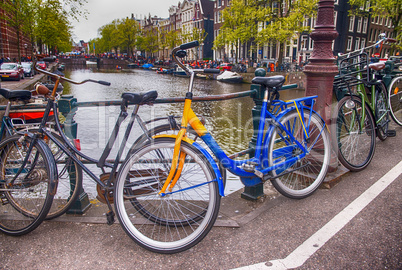 Bicycles lining a bridge over the canals of Amsterdam, Netherlan
