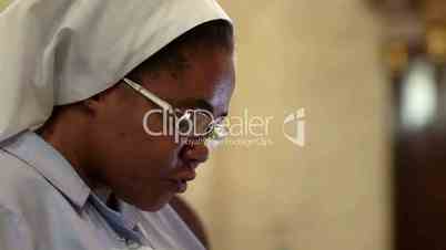 People and religion, catholic sister praying in church during mass